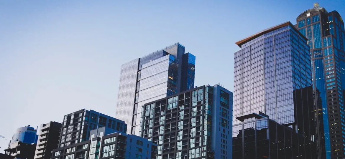 white and blue glass walled high rise building